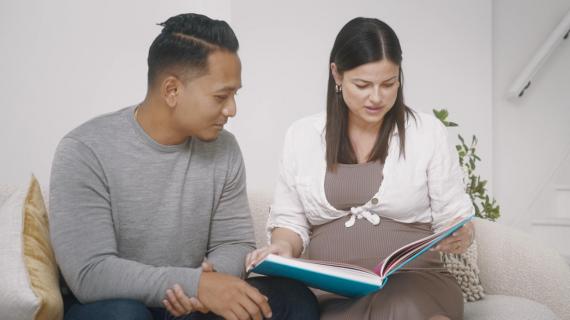 a couple reading a large book together